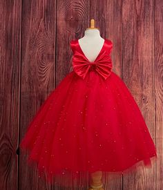 Our enchanting Ankle Length flower girl dresses are sure to turn heads! Bodice is made of Red satin, waist consists of a matching sowed in sash (NOT DETACHABLE) The back of the dress has an open deep V-Back with a hidden zipper, followed by a detachable bow. The skirt has 4 tulle layers for fullness, the top layer of tulle consists of pearls. The dress has 2 layers of lining with crinoline. This dress is perfect for any occasion!  Dress Is Pictured with a petticoat NOT INCLUDED https://www.etsy.com/listing/1305138635/white-ankle-length-petticoat-wedding?click_key=50d449c187c9e82c565249da914d7ed38b32b9f7%3A1305138635&click_sum=17db9314&ref=shop_home_active_2 Visit our store, more items to come!  https://www.etsy.com/shop/LittledarlnBoutique?ref=profile_header CUSTOM MEASUREMENTS AVAILABLE A Winter Birthday Photoshoot, Red Flower Girl, Red Flower Girl Dresses, Dress With Pearls, Cake Dress, Flower Girl Wedding, Princess Flower, Red Pearl, Winter Birthday