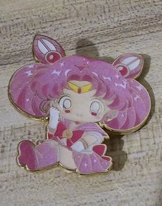 a pink and white pin with a princess sitting on the ground next to it's shadow