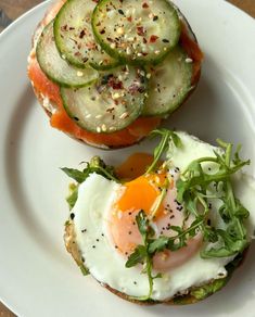 an egg and cucumber sandwich on a white plate