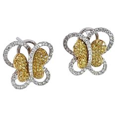 Yellow & White Diamond Butterfly Earrings. Beautiful yellow and white diamond butterflies sit nicely on your ears. These earrings are set with .57 carat round cut yellow diamonds. In addition, there are .66 carat of round white diamonds each for a total of 1.23 carats per earring.  That's a total of 2.36 carats of diamonds. I had these and a matching necklace made per my instructions. They sparkle and they come with a Certificate of Appraisal dated January 6, 2010 for $4,900.00. DIMENSIONS: Head Earring Video, Diamond Ribbon, Emerald Diamond Earrings, White Diamond Earrings, Fancy Lights, Ruby Earrings, Emerald Earrings, Sapphire Stone, Butterfly Earrings