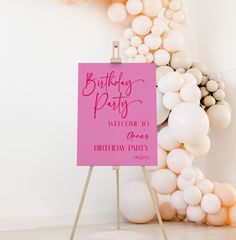 a birthday party welcome sign in front of balloons