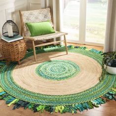 a living room area with a chair and rug on the floor next to a window