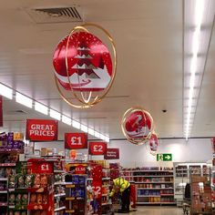 a store filled with lots of different types of christmas decorations hanging from the ceiling above