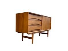 the sideboard is made from wood and has two drawers on one end, and an open drawer on the other