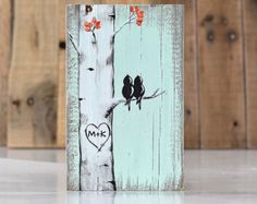 two birds sitting on a tree with the word mr and mrs painted on it