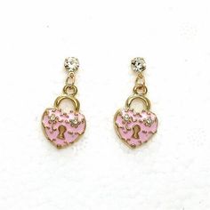 Betsey Johnson Pink Heart with Lock Rhinestone Earrings Item: Pierced Earrings Vendor: Betsey Johnson Earring Dimensions: .71" x .47" (Inches) Color: Pink, Gold Metal: Alloy Material: Enamel, Rhinestones Theme: Heart, Love, Lock All Measurements Are Approximate. Sold As One Pair Of Earrings Fun brooches, pendants, earrings, flirty necklaces, and chunky bracelets do more than just add a touch of sparkle – they represent who you are. Betsey Johnson Jewelry does this beautifully with a complete lin Gold Rhinestone Heart Earrings, Gold Heart-shaped Earrings With Rhinestones, Pink Metal Heart Earrings For Pierced Ears, Pink Heart Earrings For Pierced Ears, Heart-shaped Metal Crystal Earrings, Cute Heart-shaped Metal Earrings, Cutest Jewelry, Lock Earrings, Betsey Johnson Earrings