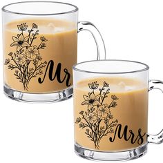 two glass mugs filled with liquid and flowers