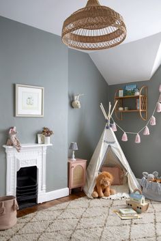 a child's room with a teepee tent and toys