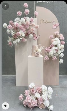 pink and white flowers in vases next to a sign