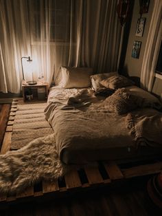 an unmade bed in a dimly lit room