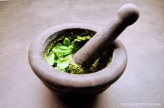 a mortar and pestle in a bowl on a table