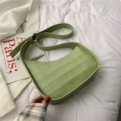 Asymmetrical shoulder bag with adjustable strap in green. Trendy Green Square Bucket Bag, Trendy Light Green Bag For Everyday Use, Trendy Green Satchel For Travel, Modern Satchel Shoulder Bag With Long Strap, Modern Long Strap Satchel Shoulder Bag, Trendy Green Everyday Satchel, Trendy Green Satchel For Everyday, Chic Rectangular Shoulder Bag With Long Strap, Trendy Green Satchel For Everyday Use