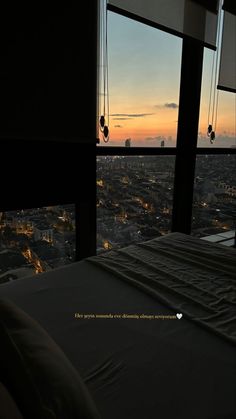 a bedroom with a view of the city at night