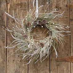 a wreath hanging on the side of a wooden wall