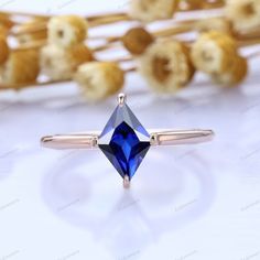 an image of a ring with a blue stone