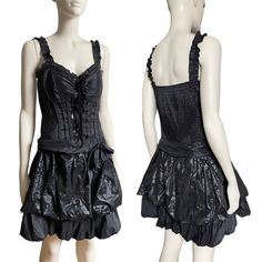 A beautiful vintage 90's french designer black victorian gothic design minidress. Featuring a ruffle skirt design with a bow on the right. A bustier top with ruffle sleeves. Gothic victorian steampunk inspired. You will definitely create a statement when wearing this dress! Measurements: The length is 88cm. Waist is 72cm. Size medium. Fits a 10 uk. Condition: In above excellent vintage condition. There are no stains, rips, marks, etc.. Please look at all the photos as they are a true representat Party Overbust Corset Dress With Ruffles, Black Underbust Corset Dress With Ruffles, Fitted Mini Corset With Ruffles, Fitted Corset Dress With Attached Cancan For Parties, Gothic Mini Corset Dress, Gothic Fitted Mini Dress With Corset Back, Fitted Gothic Corset Dress With Attached Cancan, Fitted Gothic Mini Dress With Corset Back, Vintage Fitted Corset Dress For Halloween