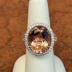 Vintage Oscar Friedman 14K white gold genuine, oval-cut, gem quality morganite with surrounding, round halo pave diamond ring Size 7 Can be resized for an additional fee up or down Genuine, oval, 12.70 carat Peach Morganite, checkerboard faceted 1.57 carat total weight natural diamonds; Mostly SI-I clarity; G /H/I color 150 diamonds Weight: 9.30 Grams Measures 24mm x 22mm top 13mm height Stamped 14KT Oscar Friedman and diamond comes with a certificate Formal Oval Topaz Ring With Halo Design, Dazzling Oval Halo Ring With Accent Stones, Dazzling Oval Topaz Ring With Halo Setting, Dazzling Oval Topaz Ring For Formal Occasions, Oval Topaz Ring With Halo Setting, Oval Topaz Ring For Formal Occasions, Oval Halo Ring For Formal Occasions, Formal Oval Topaz Ring With Halo Setting, Oval Topaz Ring With Diamond Accents