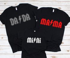 two black shirts with the word mama and dad printed on them, sitting next to each other