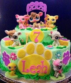 a birthday cake decorated with littlest pets and the number seven on it's side