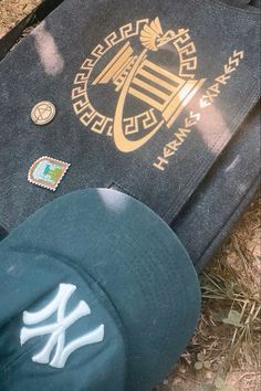 a baseball cap laying on the ground next to a bag