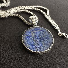 PENDANT STONE: Lapis Lazuli (natural) METAL : .925 Sterling Silver DIMENSIONS : 30 x 30 mm CHAIN: Byzantine King chain METAL : .925 Sterling Silver LENGHT: 55 cm - 21.65 inches THICKNESS: 3 mm - 0.1 inches Spiritual Sterling Silver Etched Necklaces, Sterling Silver Engraved Necklaces For Meditation, Spiritual Etched Sterling Silver Necklaces, Spiritual Etched Sterling Silver Necklace, Handmade Spiritual Sterling Silver Necklace, Symbolic Blue Engraved Necklaces, Artisan Engraved Necklace, Artisan Engraved Necklace As Gift, Artisan Engraved Necklace For Gift