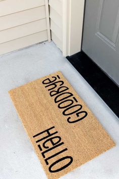 a door mat that says goodbye and has the words hello written in black on it