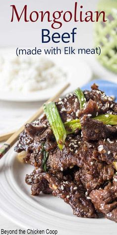 the beef dish is served on a plate with chopsticks and rice in the background