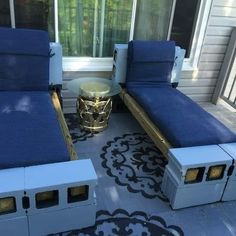 two blue couches sitting next to each other on a patio