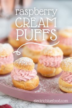 raspberry cream puffs with powdered sugar on top