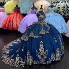 several dresses are displayed on mannequins in a room full of gowns