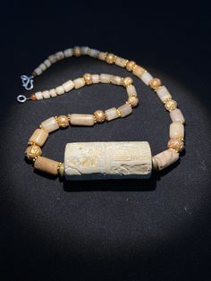 old ancient antique roman cylinder seal with stone age crystals quartz beads by uddiyanaart on Etsy Antique Carved Jewelry For Rituals, Antique Gold Necklace With Carved Details, Ancient Handmade Ceremonial Jewelry, Handmade Ancient Ceremonial Jewelry, Handmade Ancient Jewelry For Ceremonial Use, Ancient Style Gemstone Beads Jewelry Gift, Ancient Style Gemstone Beads Jewelry For Gift, Antique Jewelry With Natural Stones For Healing, Ancient Handmade Healing Necklace