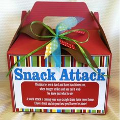 a small red box with a ribbon on the top that says snack attack