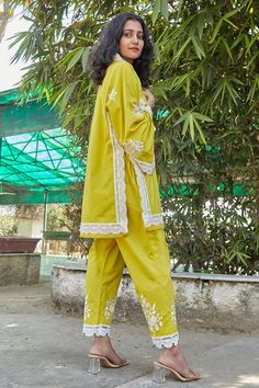 Yellow kurta with embroidered floral patterns and lacework. Comes with pant.
Components: 2
Pattern: Embroidered
Type Of Work: Floral
Neckline: V-neck
Sleeve Type: Full
Fabric: Organic Cotton
Color: Yellow
Other Details: 
Straight silhouette
Length:
Kurta: 33 inches
Pant: 37 inches
Occasion: Party,Mehendi and Haldi - Aza Fashions Yellow Kurta, Pant For Women, Kurta With Pants, Summer Floral, Floral Patterns, Aza Fashion, Sleeve Type, Floral Pattern, Types Of Sleeves