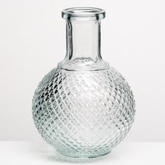 a clear glass vase sitting on top of a table