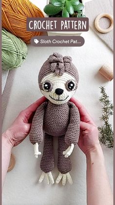 a crocheted stuffed slotty is being held up by someone's hand