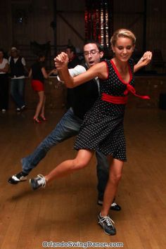 two people are dancing on the dance floor