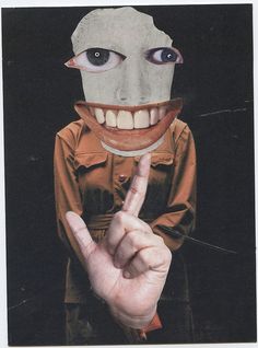 a person wearing a creepy mask making the peace sign with their hand while standing in front of a black background