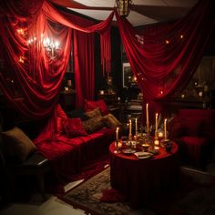 a living room with red drapes and candles