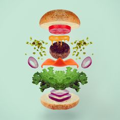 an advertisement with hamburgers and lettuce in the shape of a tower on top of each other