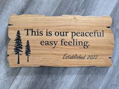 this is our peaceful easy feeling engraved on a wood plaque with pine trees and the words,'this is our peaceful easy feeling '