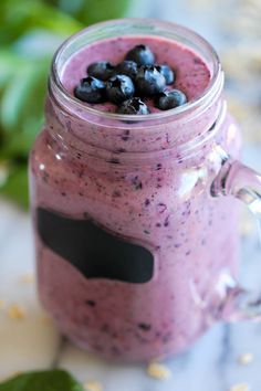 a jar filled with blueberries sitting on top of a table