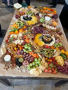 a table topped with lots of different types of fruit and veggies on it