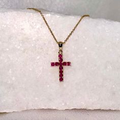 A timeless and classic design, symbolizing faith and love. Perfect for everyday wear or dressed up for special occasions. Make a bold statement in our Genuine Ruby Cross Pendant, available in 14k solid white gold and 14k solid yellow gold. 14k solid white gold chain and 14k solid yellow gold chain available for purchase to match your beautiful pendant. Item Specifications: Materials: 14k Solid Gold  Gemstone: Natural Rubies Pendant Diameter 13.5 mm x 9.7 mm Total Gold Weight: 0.40 gram Total Rub Classic 14k Stamped Cross Jewelry, 14k Gold Cross Jewelry For Anniversary, Classic Yellow Gold Crucifix Jewelry, Classic Crucifix Jewelry With Polished Finish, Classic Polished Crucifix Jewelry, Elegant Stamped 14k Gold Crucifix Jewelry, Stamped 14k White Gold Cross Jewelry, Elegant Stamped 14k Crucifix Jewelry, 14k Gold Crucifix Jewelry For Anniversary