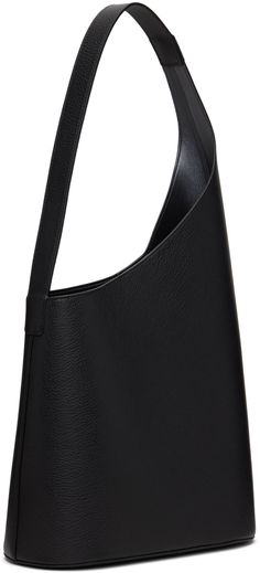 Grained calfskin tote in black. · Integrated shoulder strap · Logo graphic embossed at face · Magnetic closure · Patch pocket at interior · Grained faux-leather lining · H22.5 x W11.75 x D5.5 Supplier color: Grain Black Black Calf Leather Shoulder Bag With Smooth Grain, Modern Calf Leather Shoulder Bag With Soft Leather, Everyday Black Calf Leather Shoulder Bag, Black Calf Leather Shoulder Bag For Everyday, Modern Leather Shoulder Bag With Leather Backing, Modern Textured Leather Shoulder Bag For Business, Sleek Leather Shoulder Bag With Smooth Grain, Office Calf Leather Bag With Leather Backing, Office Bag With Leather Backing In Calf Leather