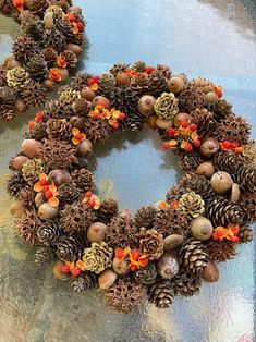 two wreaths made out of pine cones and acorns