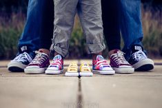 two people standing next to each other with their feet on the ground