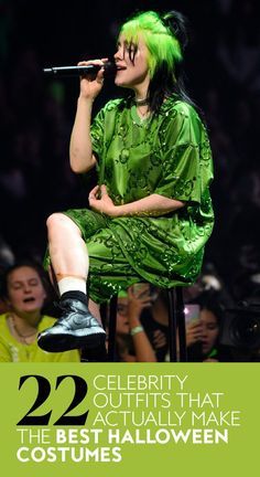 a woman with green hair sitting on top of a chair in front of a crowd