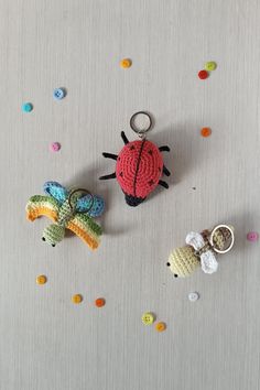 two crocheted animals sitting next to each other on top of a metal surface