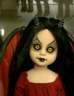 a doll with long black hair and yellow eyes