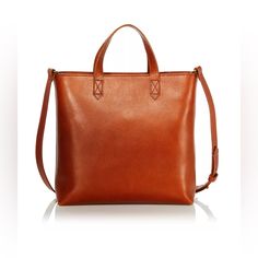 Madewell Small Transport Leather Crossbody Tote Bag Retail Price $158.00 + Tax Clean, Modern And Completely Unfussy, This Roomy Leather Tote Is Topped With Comfortable Top-Carry Handles And A Convenient Optional Crossbody Strap For When You Want To Wear The Style Hands-Free. The Usa Vegetable-Tanned Leather Develops A Beautiful Patina Over Time, While The Top-Zip Closure Ensures All Your Everyday Necessities Stay In Place. Approx Measurements: * Top Handles, 3.25" Drop * Removable, Adjustable Shoulder Strap, 20.9-22.9" Drop * Dimensions: 9.75"W X 3"D X 10"H * Zip Closure * Interior Slip Pocket * Leather In Excellent Preowned Condition. Stored In A Smoke Free And Climate Controlled Envir Classic Orange Shoulder Bag With Detachable Strap, Classic Orange Bag With Detachable Strap, Versatile Cognac Bag With Smooth Grain, Classic Orange Crossbody Shoulder Bag, Classic Orange Top Handle Satchel, Chic Orange Leather Bags, Classic Orange Crossbody Bag, Chic Orange Leather Satchel, Modern Orange Leather Satchel